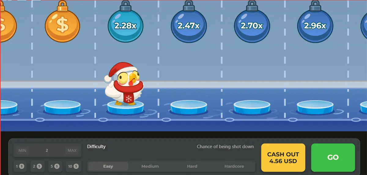 Screenshot of a winter-themed Chicken Road-style game showing a small chicken in a Santa hat on icy stepping stones, with hanging multiplier bombs above (2.28x, 2.47x, 2.70x, 2.96x) and a bottom bar for bet and difficulty settings plus “CASH OUT 4.56 USD” and a green “GO” button.